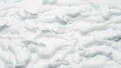 spray foamWhite foam texture abstract art background. Closeup of surface covered with whipped cream.