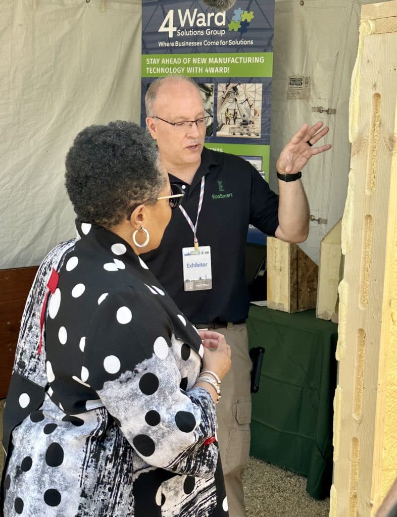 U.S. Housing and Urban Development Secretary Marcia Fudge visits with EcoSmart Stud creator Jon Pues on June 9 at the Innovative Housing Showcase in Washington, D.C.